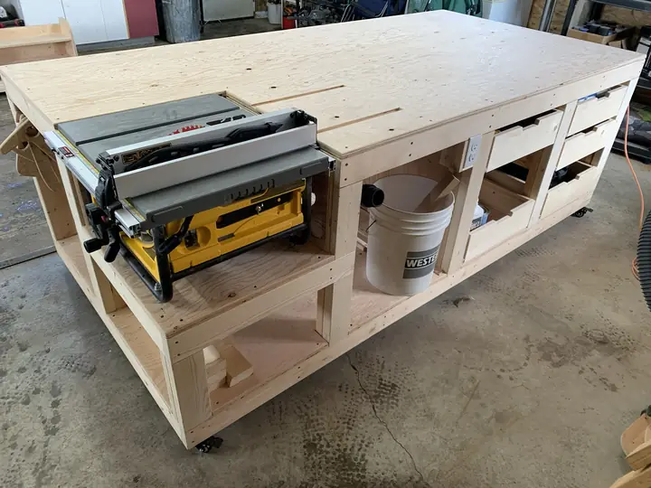 Large plywood workbench with a table saw built into it